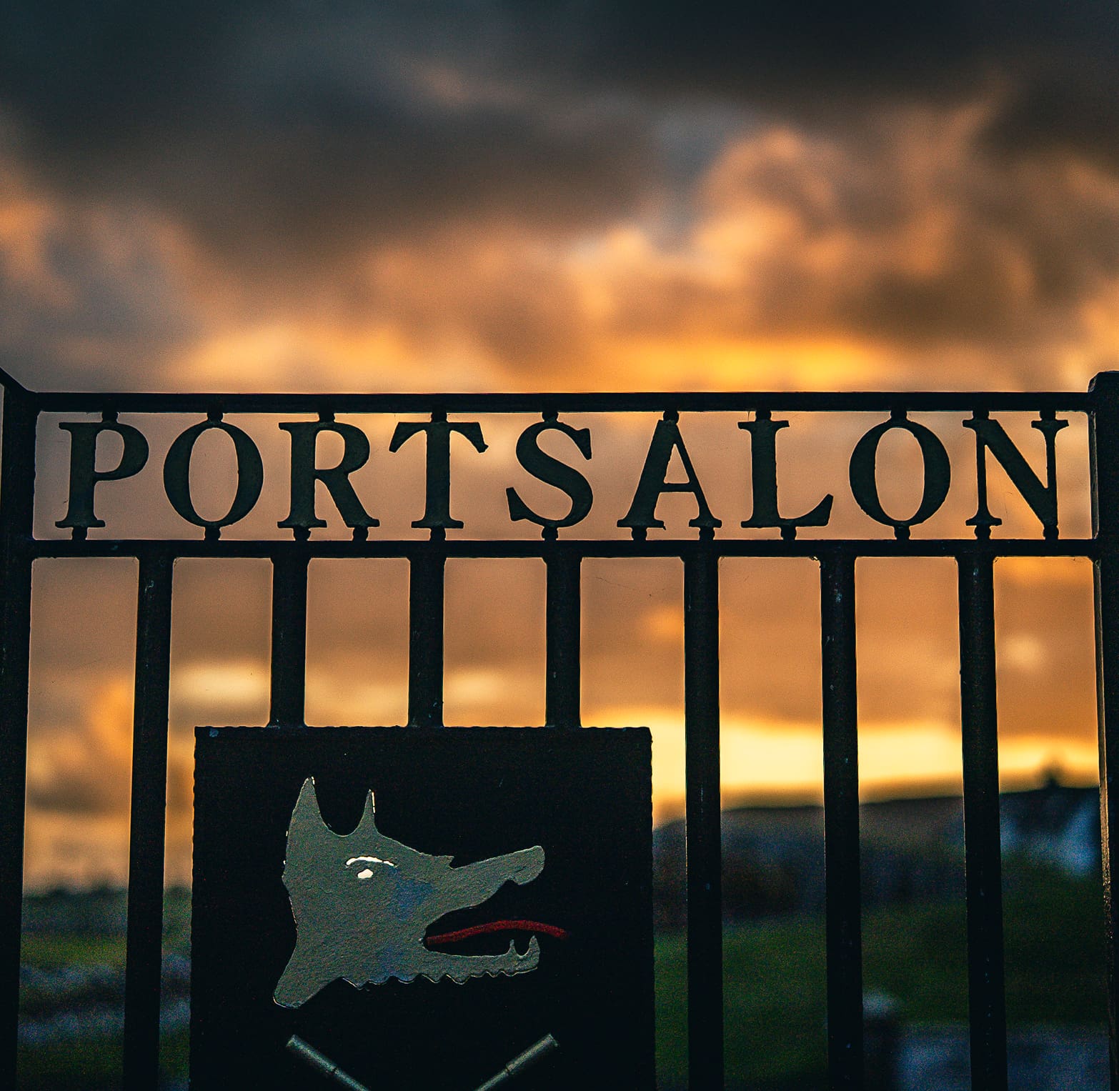 Portsalon entry gate with a sunset in the background.